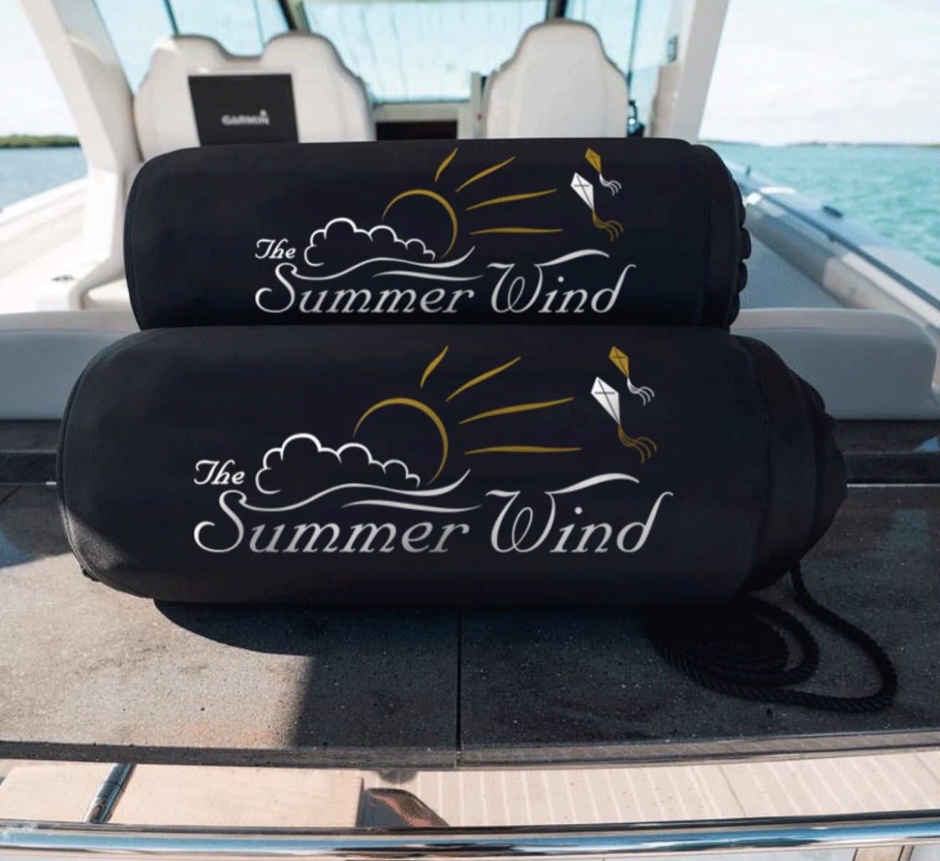 The Summer Wind custom boat name fender covers with sun and kite artwork on center console