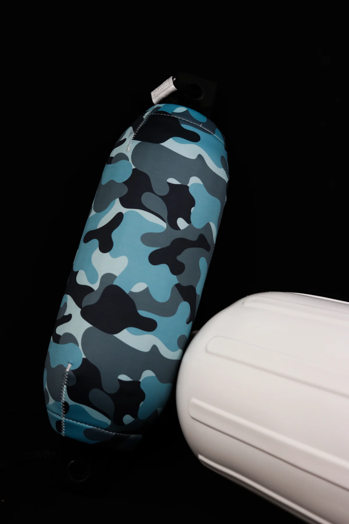 Blue camouflage custom FenderSox displayed beside its white boat fender