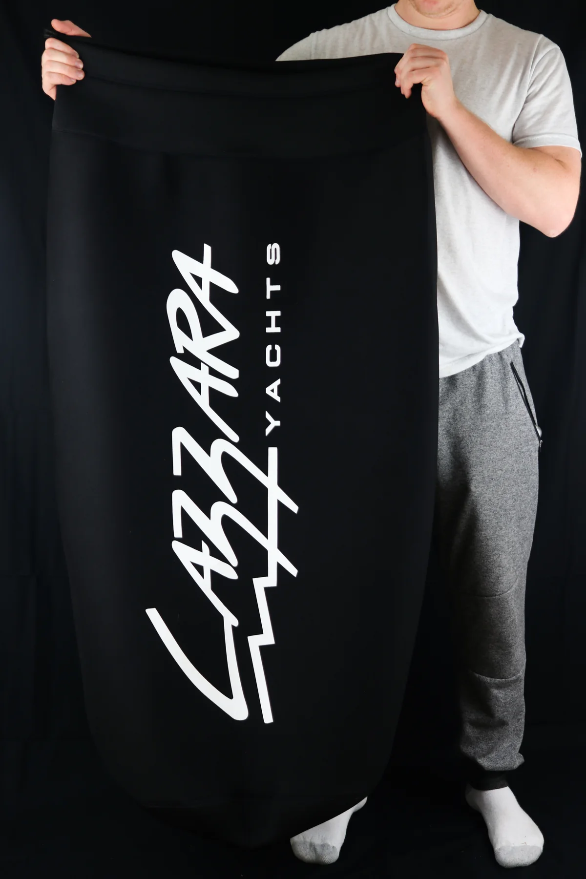 Crew member holding an oversized La Azzurra Yachts custom FenderSox cover