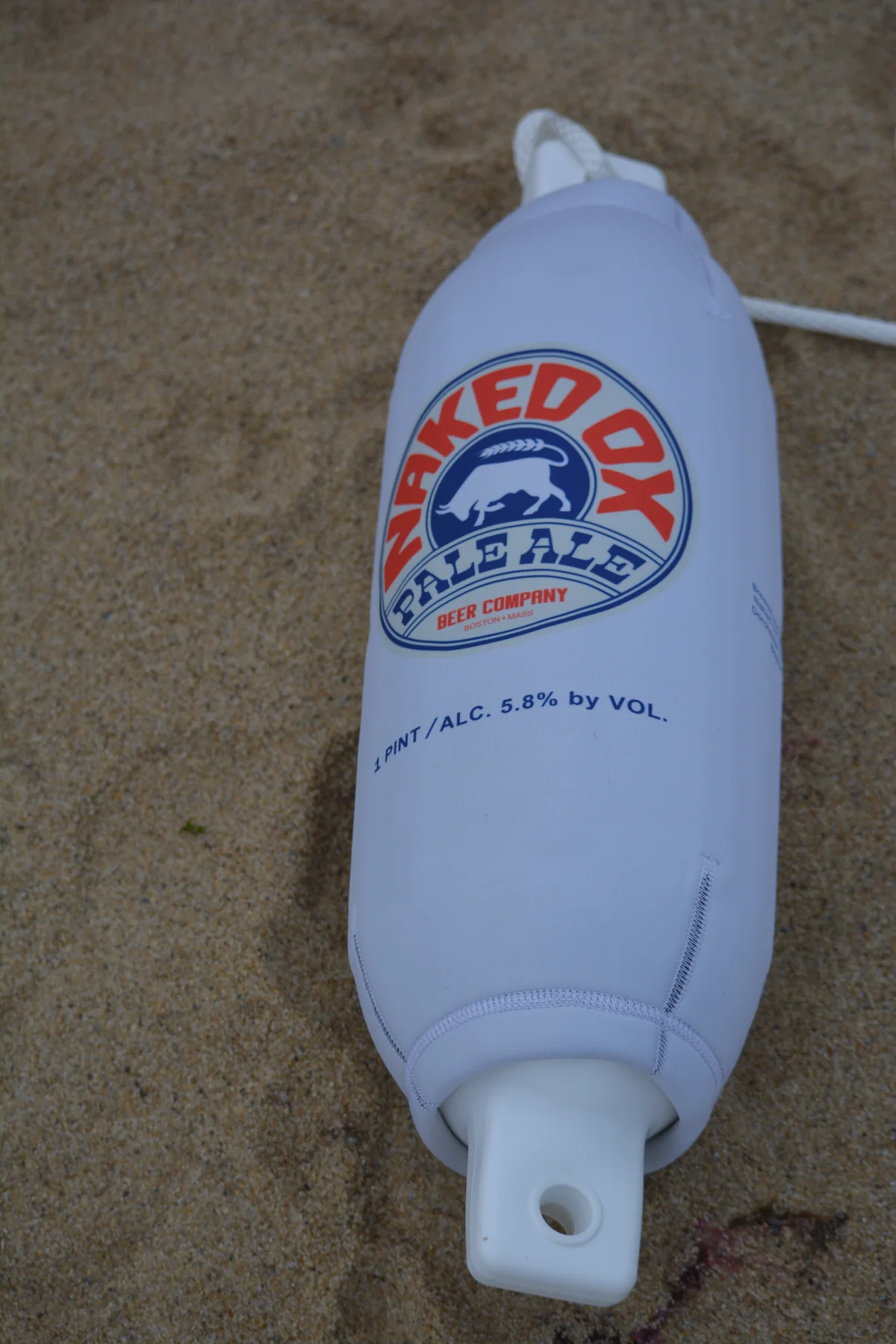 Naked Ox Pale Ale branded custom FenderSox photographed on the sand