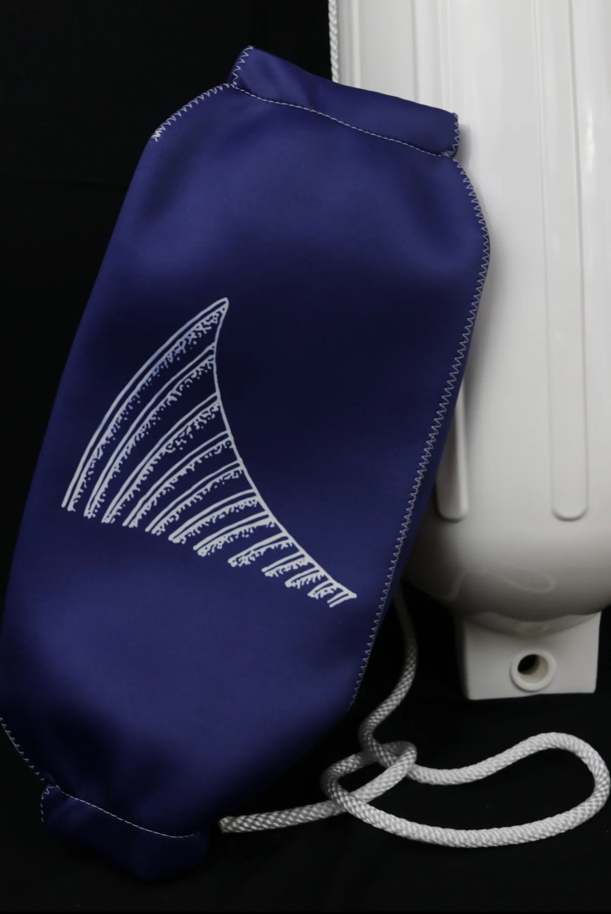 Navy custom FenderSox with a hand-drawn fin graphic beside a white fender