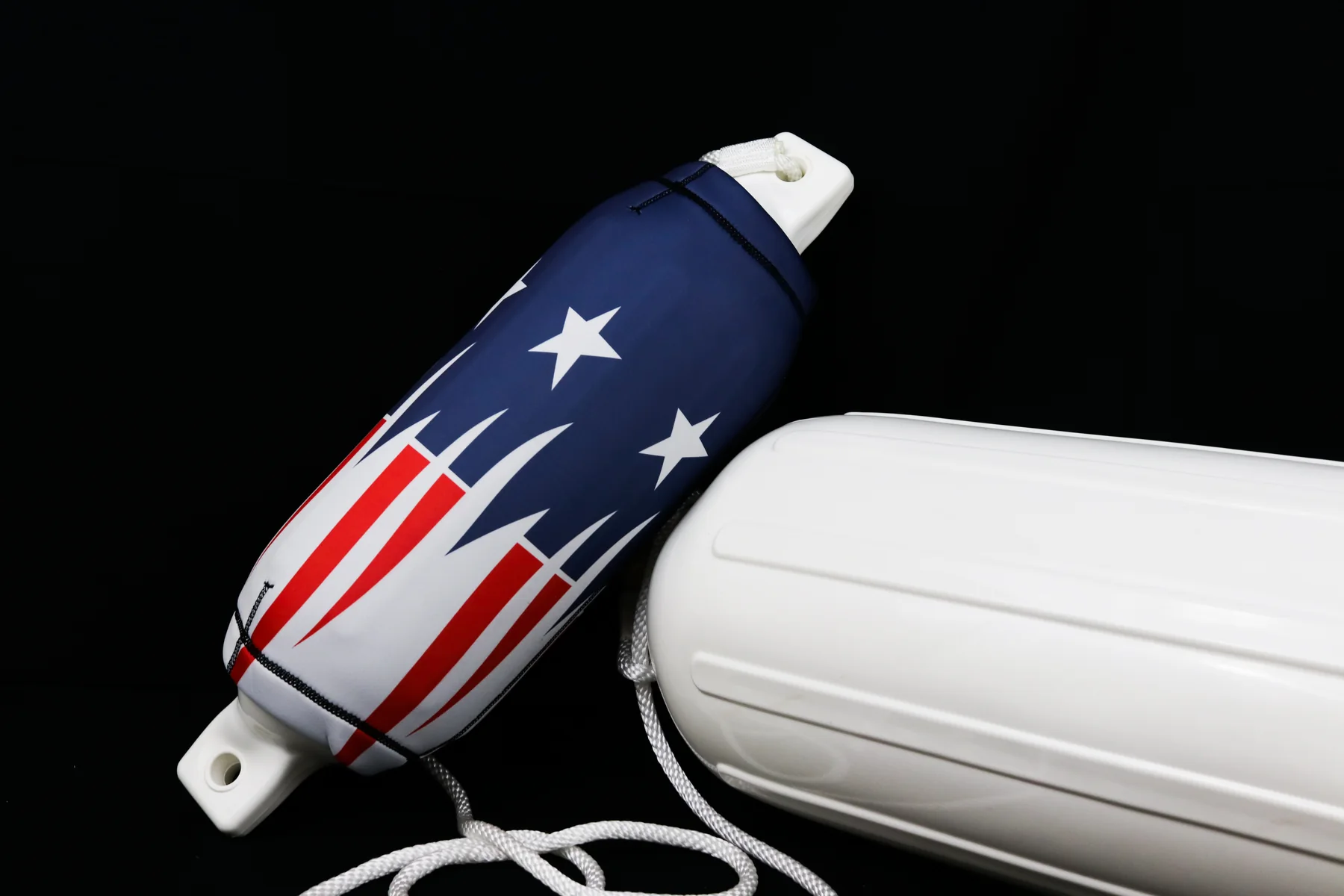 Patriotic star and red stripe burst custom FenderSox beside a white boat fender