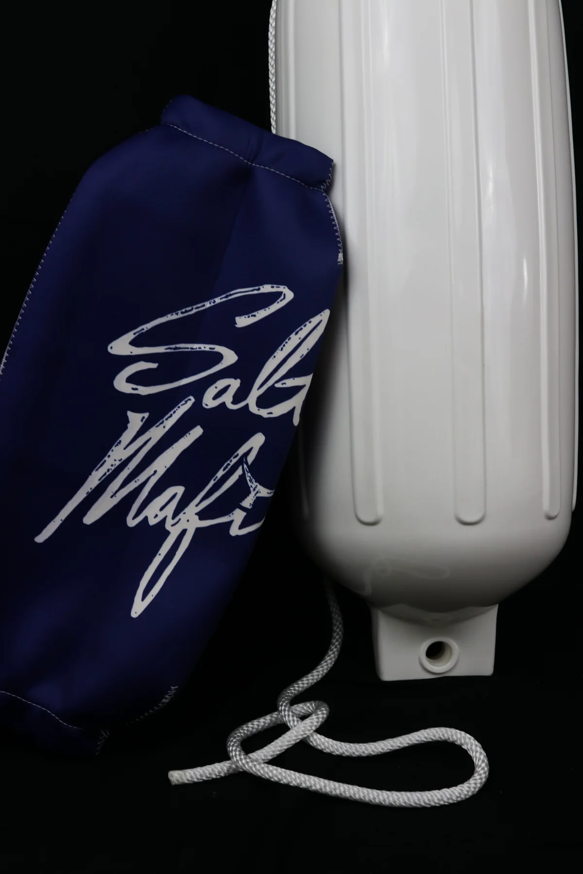 Sailing Mafia custom neoprene cover displayed beside its uncovered white boat fender