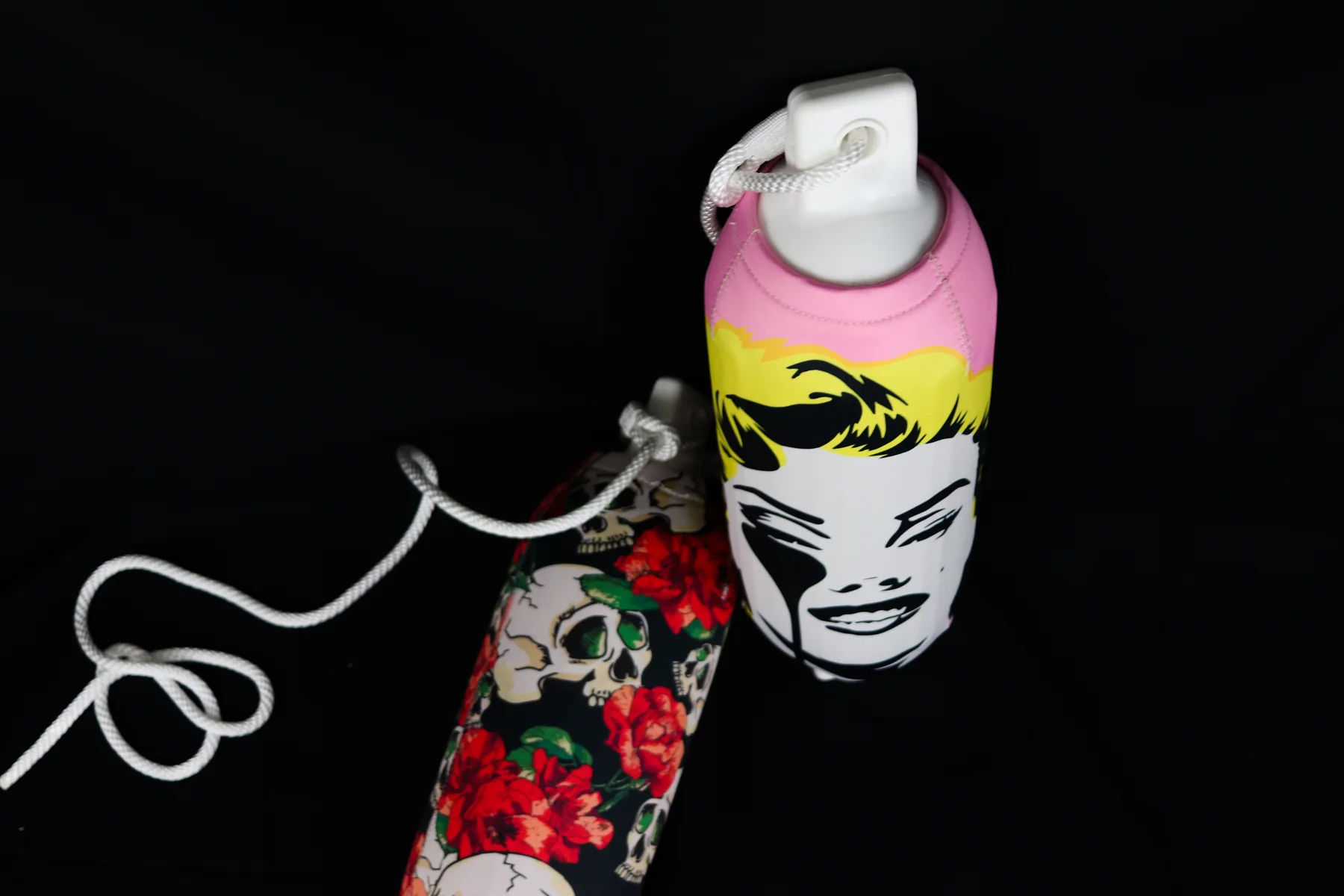 Skull-and-rose and pop-art portrait custom FenderSox arranged as a matching pair