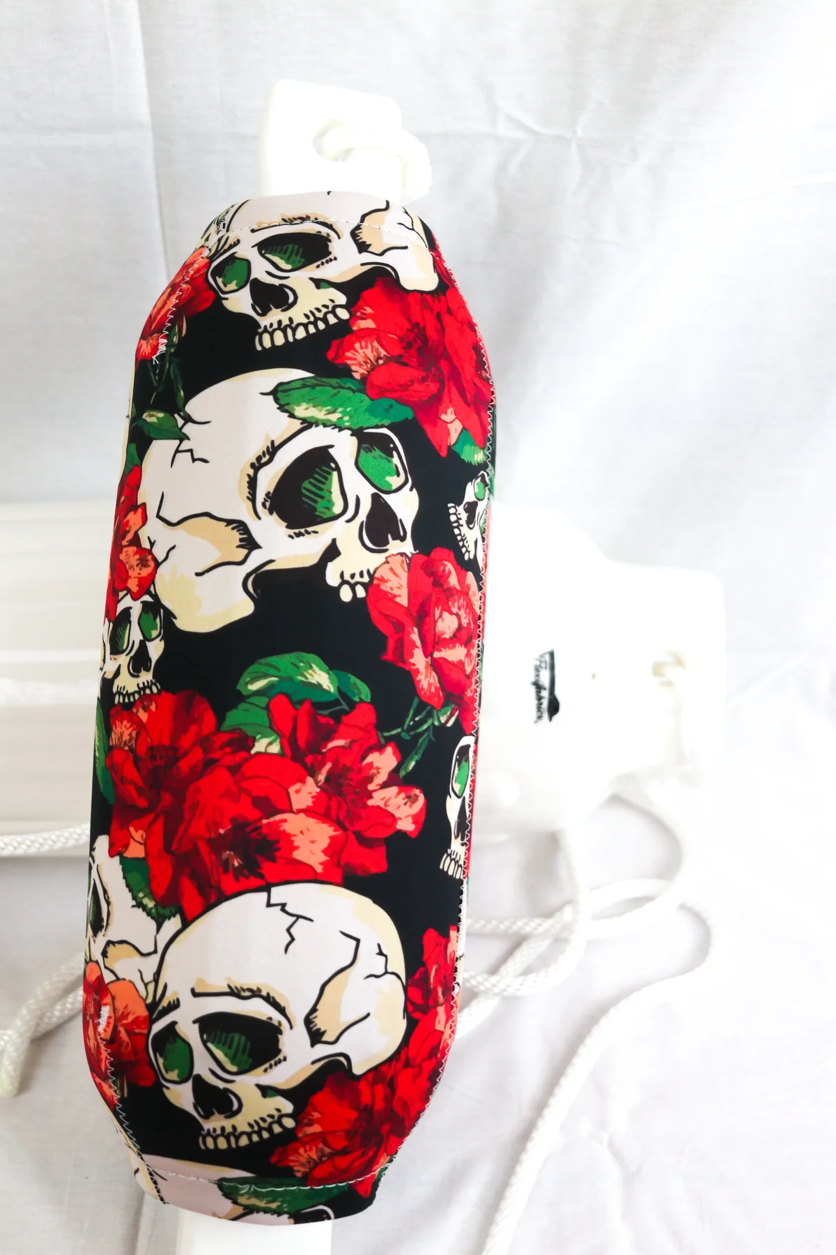Skulls and red roses custom FenderSox displayed against a white studio background