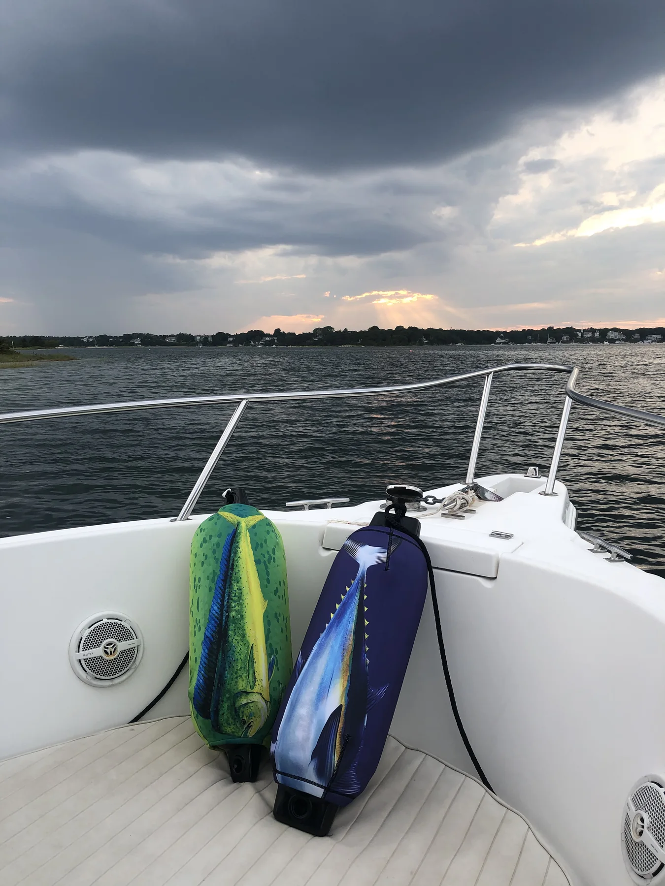 Mahi artwork FenderSox pair secured on a boat deck beneath a dramatic sky